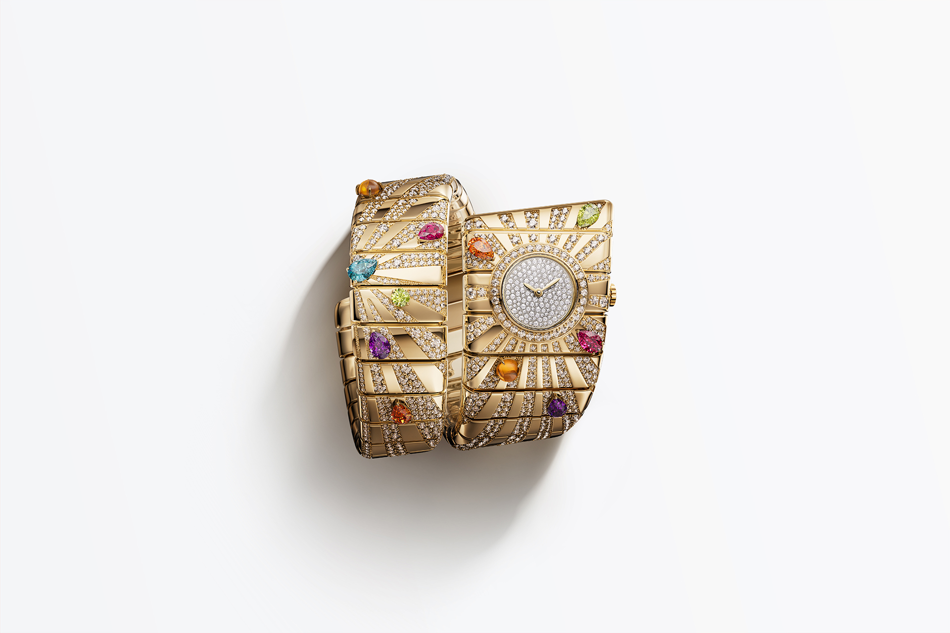gold cuff bracelet with dense gemstone setting and integrated watch