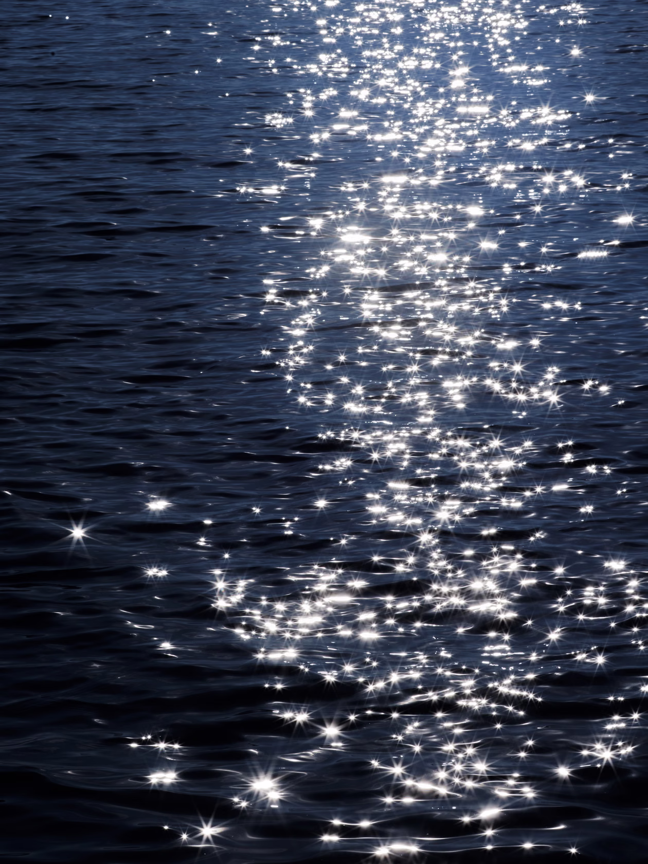 sunlight reflections on water creating sparkling linear patterns