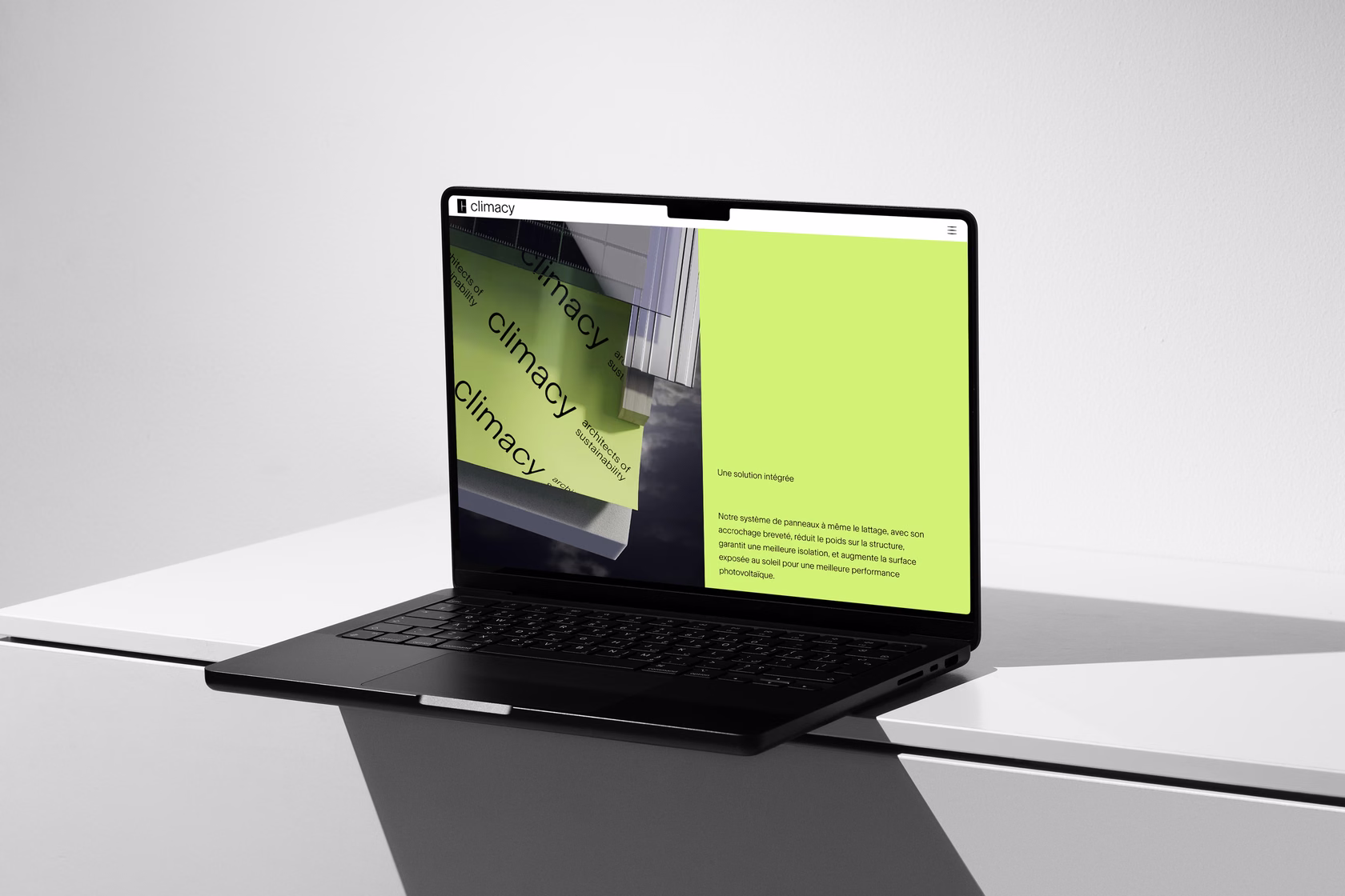 Laptop displaying climacy visual identity with bright green interface layout