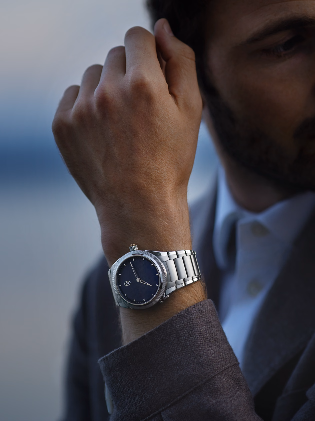 wristwatch worn outdoors with natural light and landscape context