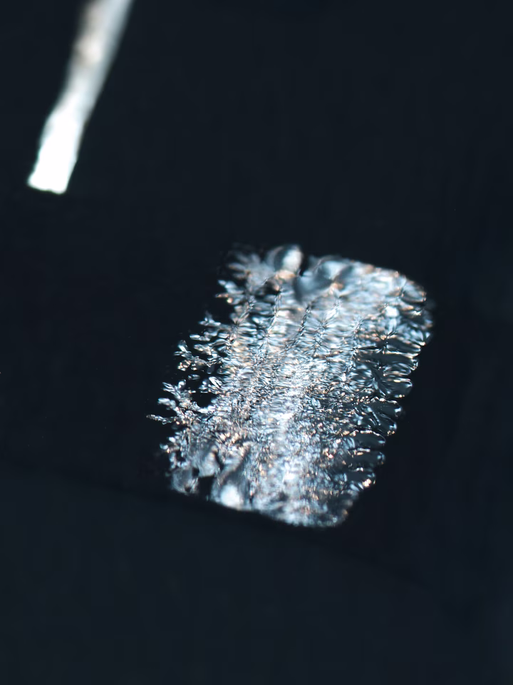 Close-up of photovoltaic surface with linear cell pattern and reflections