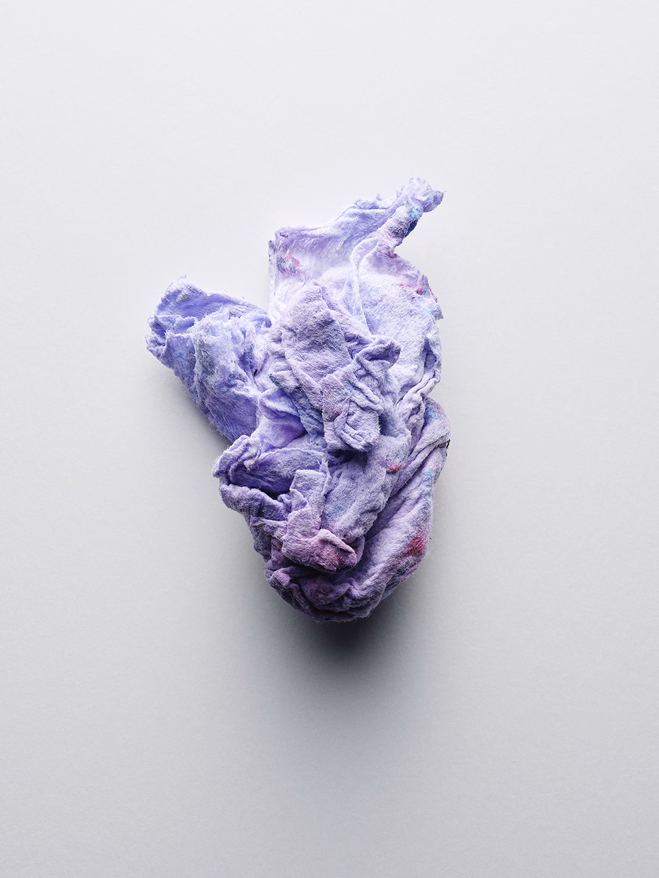 Still life of crumpled textile with soft folds and subtle color tones