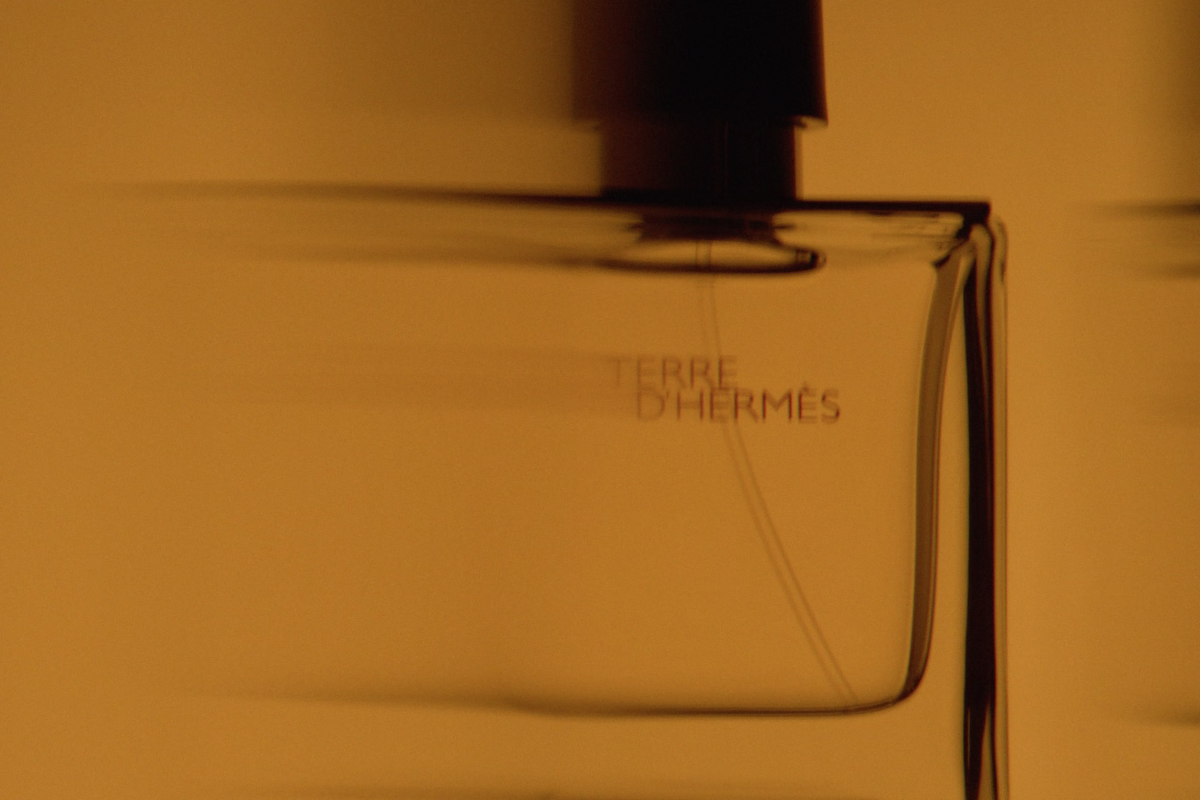 perfume bottle in amber light showing depth and transparency