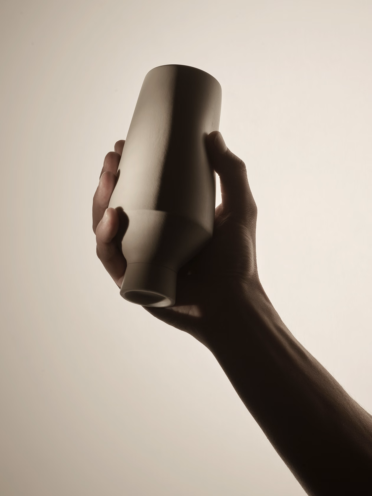 Hand holding silicone container demonstrating grip and ergonomic form
