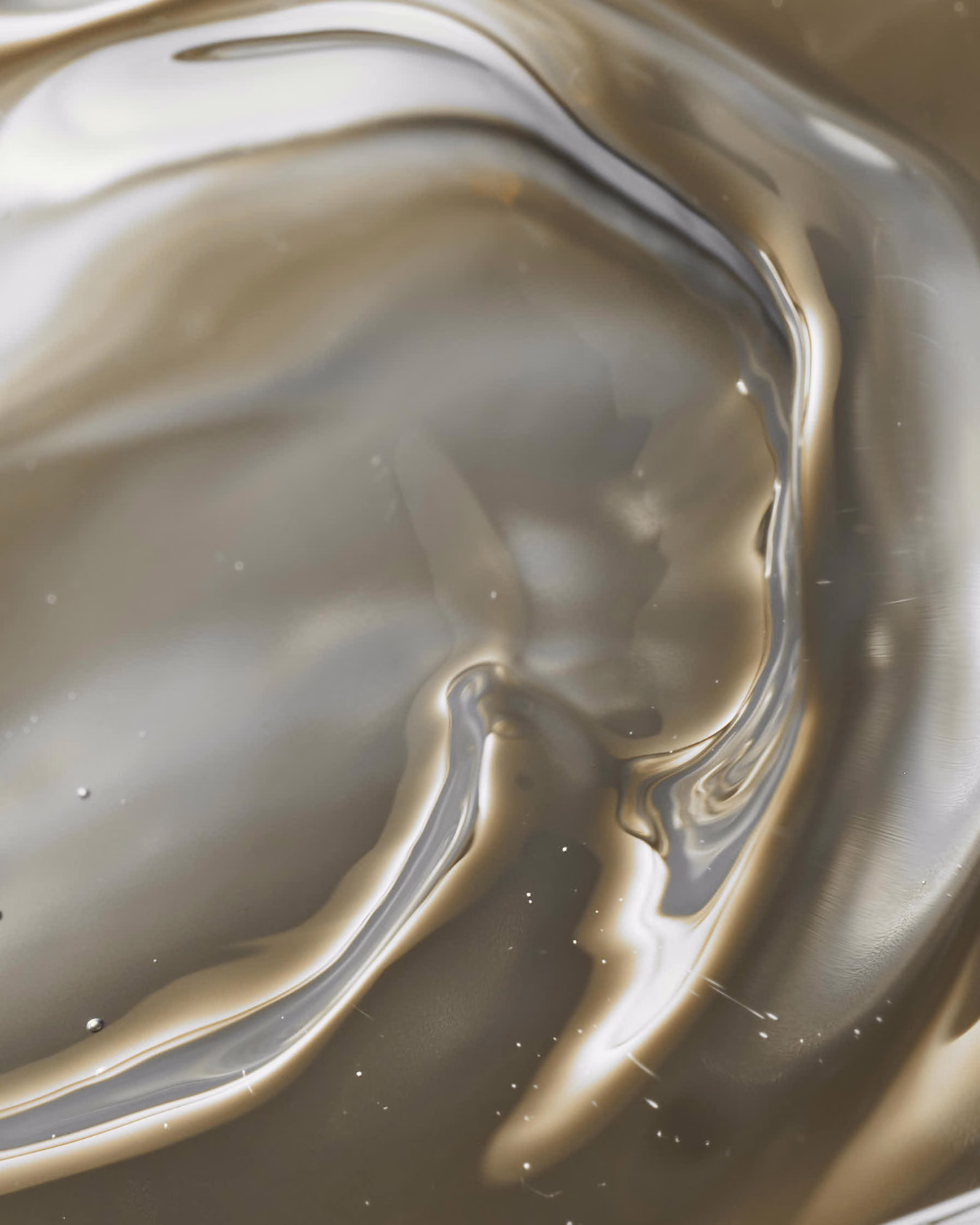 close-up liquid surface with golden reflections and smooth distortion