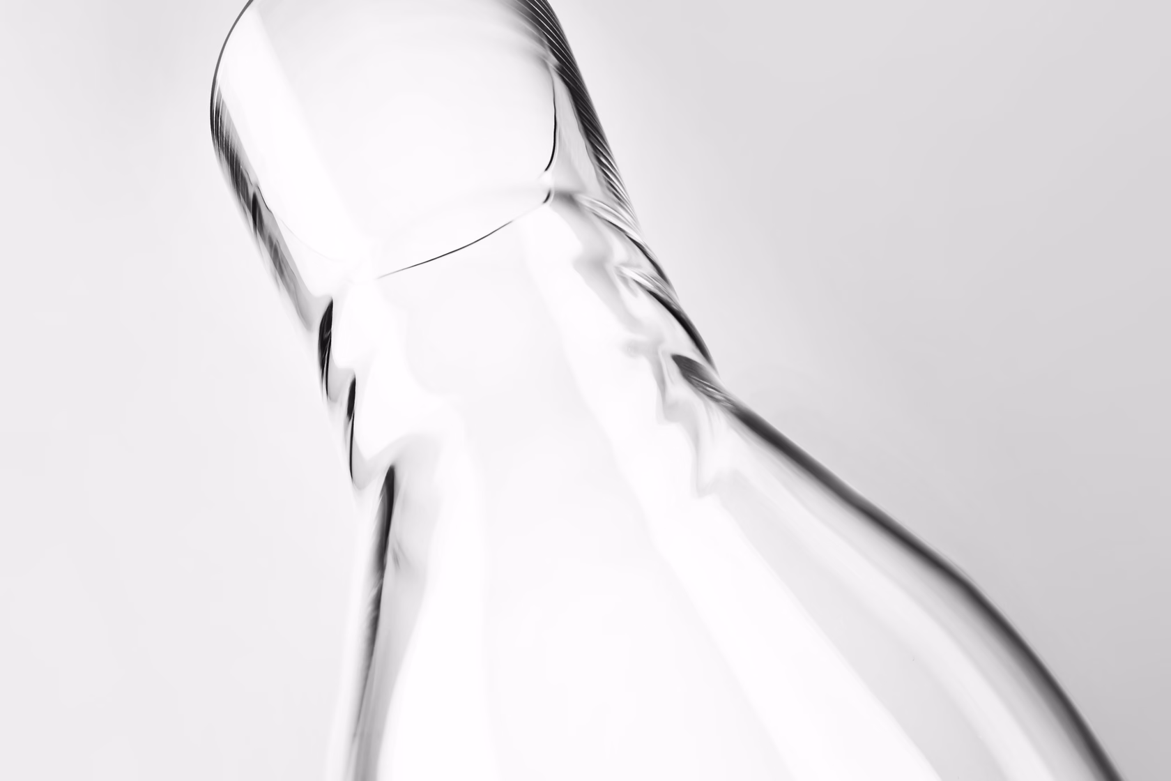 Close-up of glass water carafe neck and pouring edge