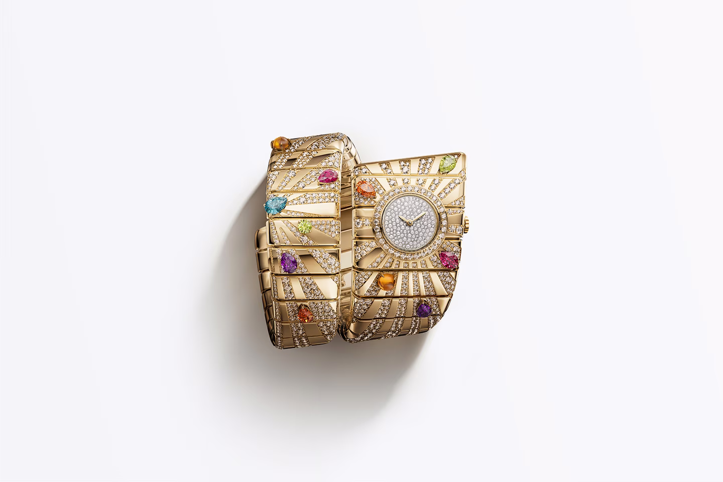 gold cuff bracelet with dense gemstone setting and integrated watch